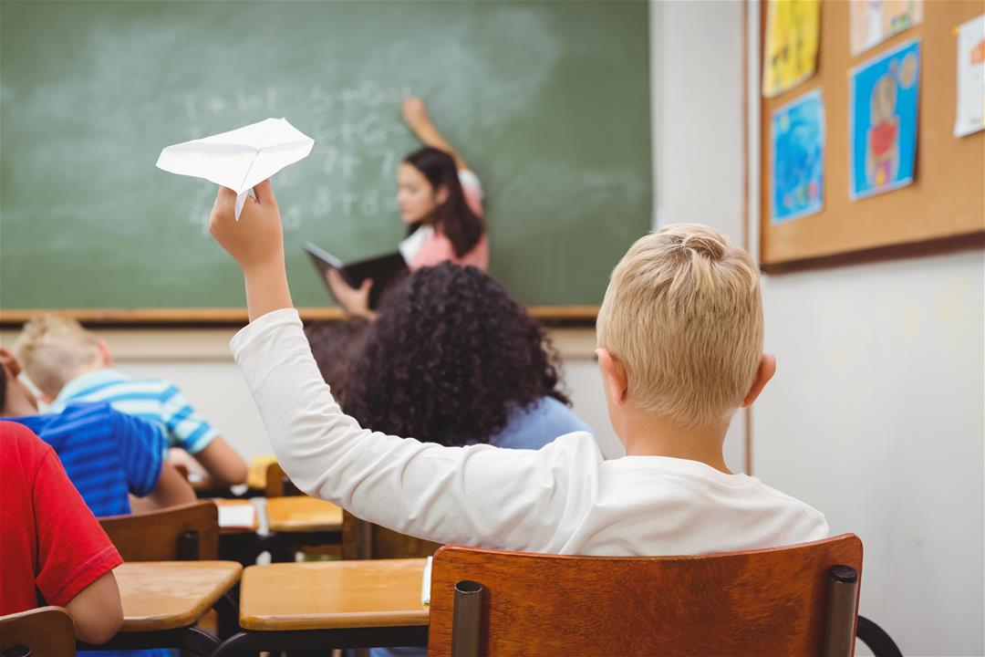 Student with paper airplane